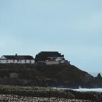 A scenic view of Pigeon Point Lighthouse and seashore in Pescadero, California.