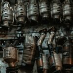 Rows of used catalytic converters in an automotive workshop setting.