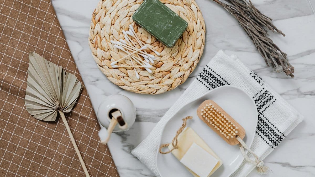 Eco-friendly bath items including soap and q-tips on a stylish flat lay.