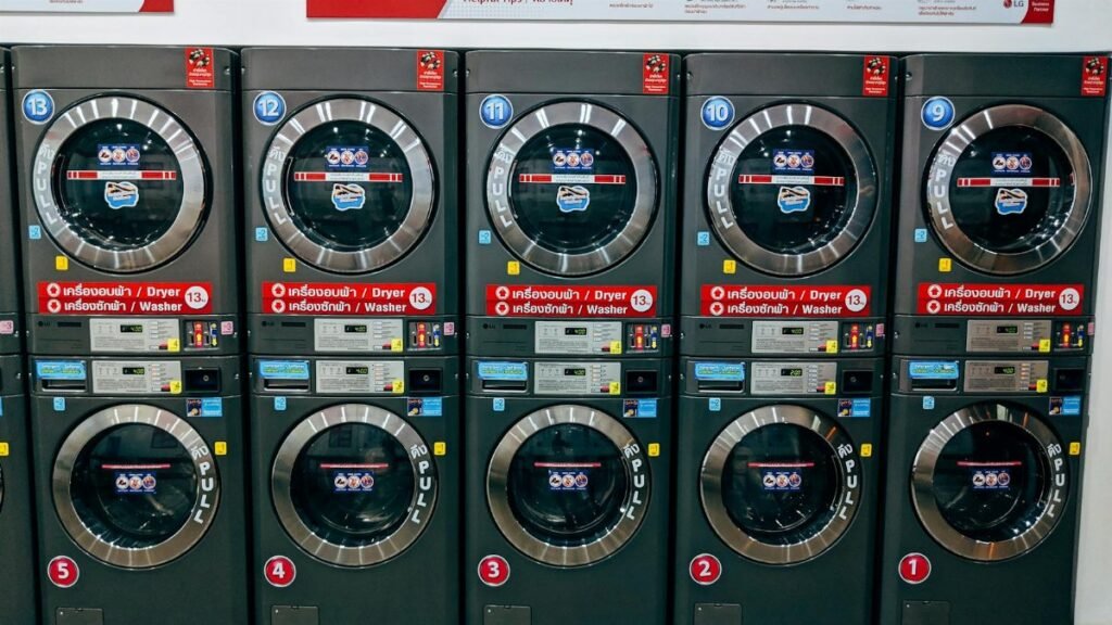 A row of modern washing machines in a public laundromat in Chiang Mai, Thailand.