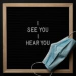 Inspirational text with a face mask displayed on a blackboard, highlighting health awareness.