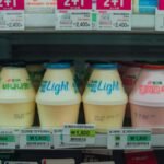 Vibrant assortment of Korean drinks in a convenience store fridge in Seoul, South Korea.