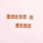 Scrabble tiles display 'Thank U Next' on a clean white background, perfect for creative projects.