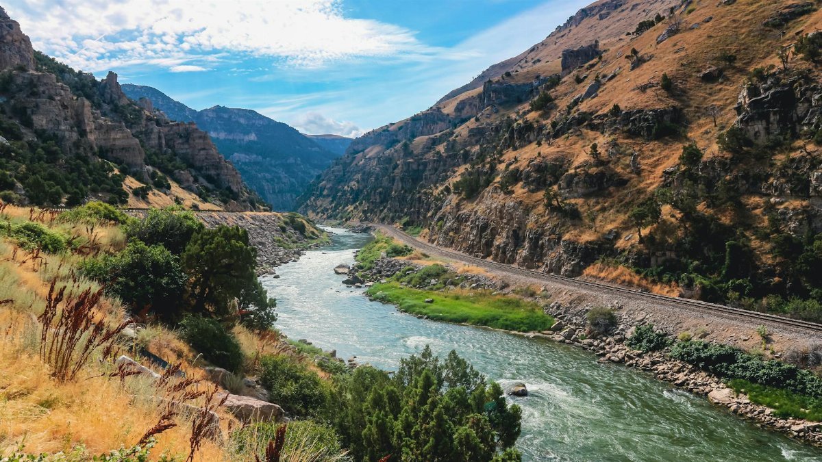 Beautiful view of a river flowing through a mountainous landscape in Wyoming.