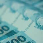 Detailed view of 100 Brazilian real banknotes, emphasizing currency and finance theme.