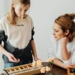 A mother and daughter engaged in puzzle-solving, enhancing creativity and bonding indoors.