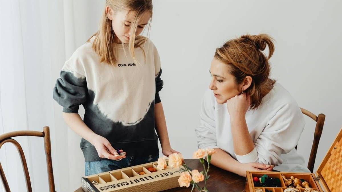 A mother and daughter engaged in puzzle-solving, enhancing creativity and bonding indoors.