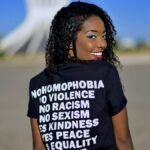 Portrait of a woman in DF, Brazil, promoting equality with positive messages on her shirt.