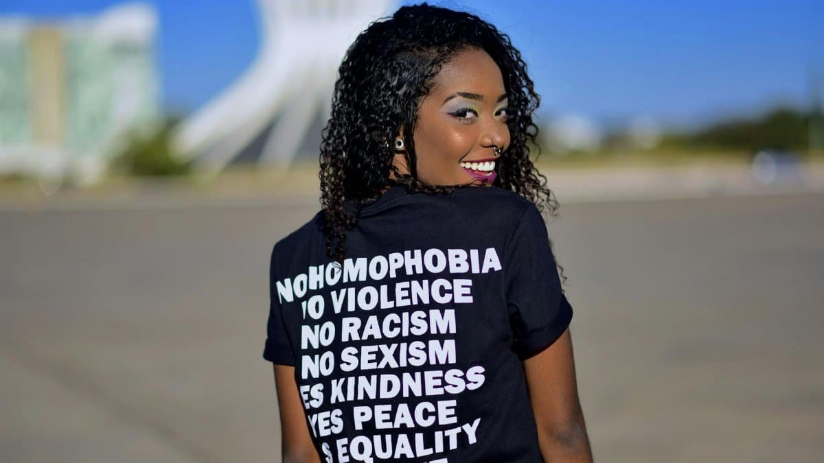 Portrait of a woman in DF, Brazil, promoting equality with positive messages on her shirt.
