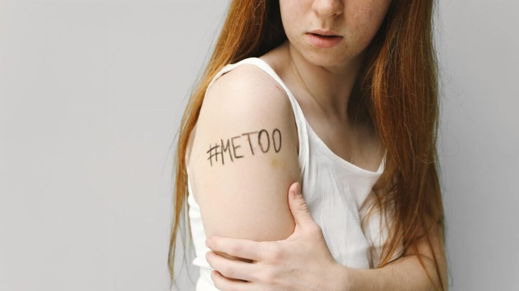 Portrait of a woman with #MeToo written on her arm, symbolizing empowerment and awareness.