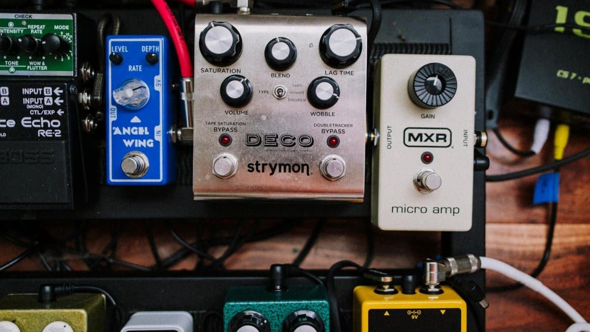 High-angle view of a musician's pedalboard featuring several guitar effects pedals.