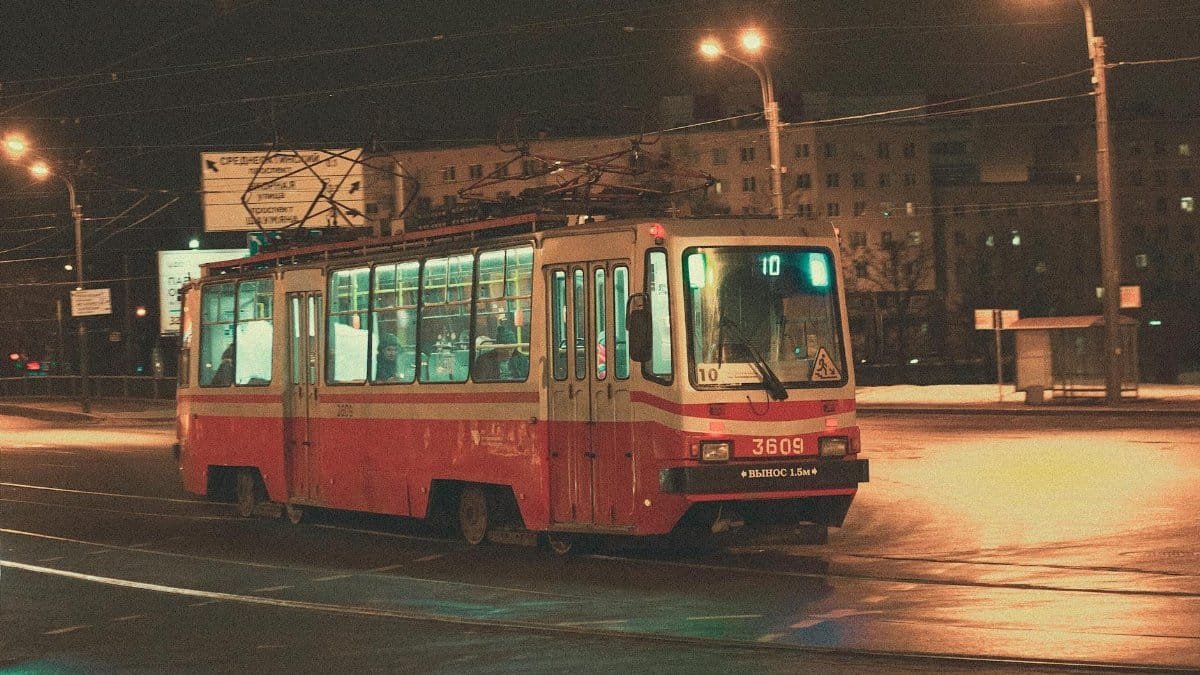 A classic tram captured at night in urban Saint Petersburg, highlighting public transportation.