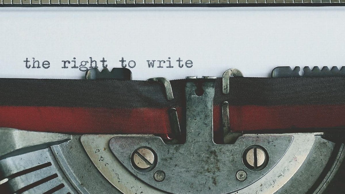 Close-up of a vintage typewriter with 'the right to write' typed on paper.