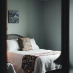 A soothing minimalist bedroom with cozy vibes, featuring a wooden bedframe and subtle decor.