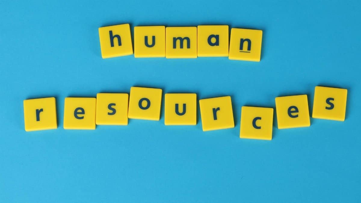 Yellow tiles spelling 'human resources' on a blue background, ideal for HR or business concepts.