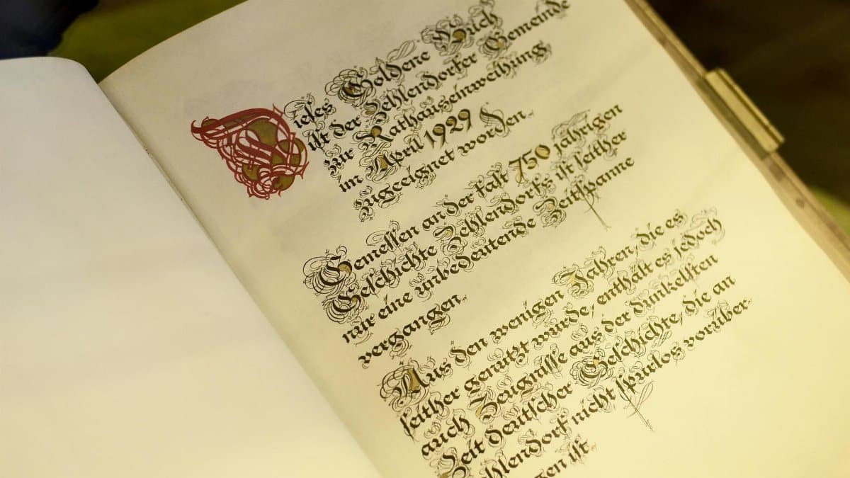German manuscript with calligraphy text in an antique book, showcasing historical typography.