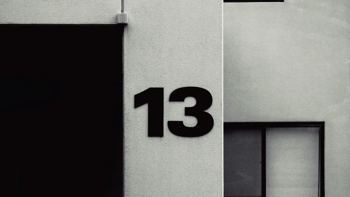 High-contrast facade featuring the number 13 on a modern building exterior.