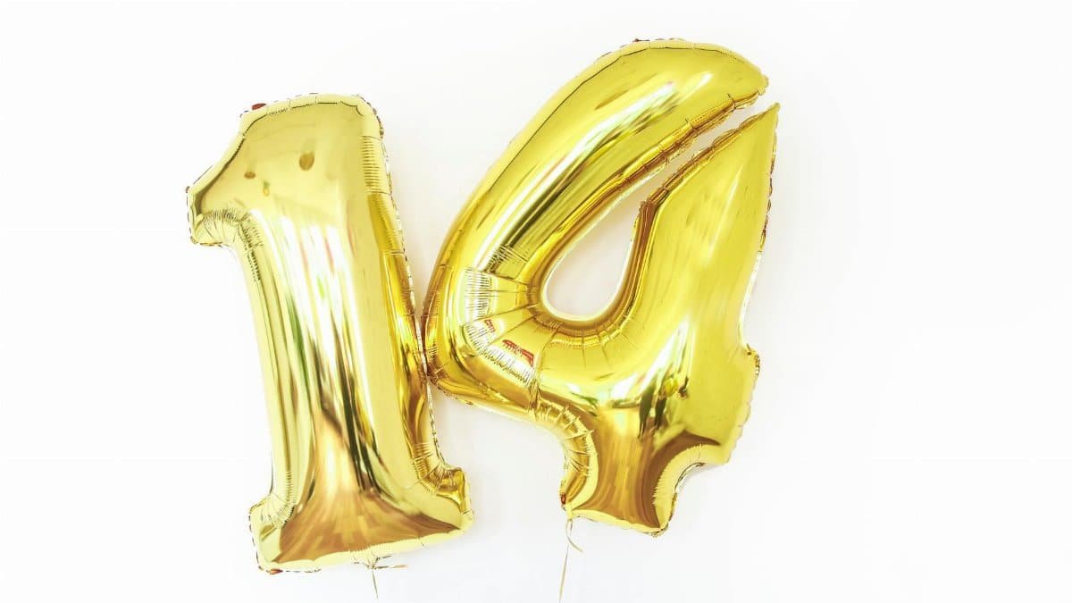 Shiny gold metallic number 14 balloons on a white background, perfect for celebrations.