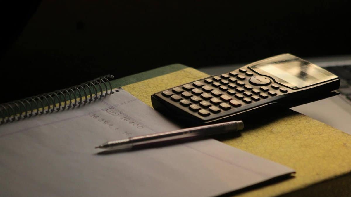 Close-up of a calculator and notebook on a study desk. Ideal for education themes.