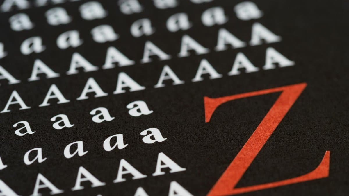 Artistic close-up of alphabet letters on black background highlighting typography design.