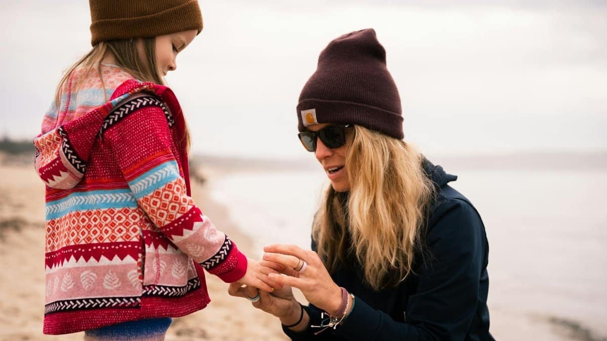 A mother and her daughter share a joyful moment on a beach in Petoskey, Michigan.