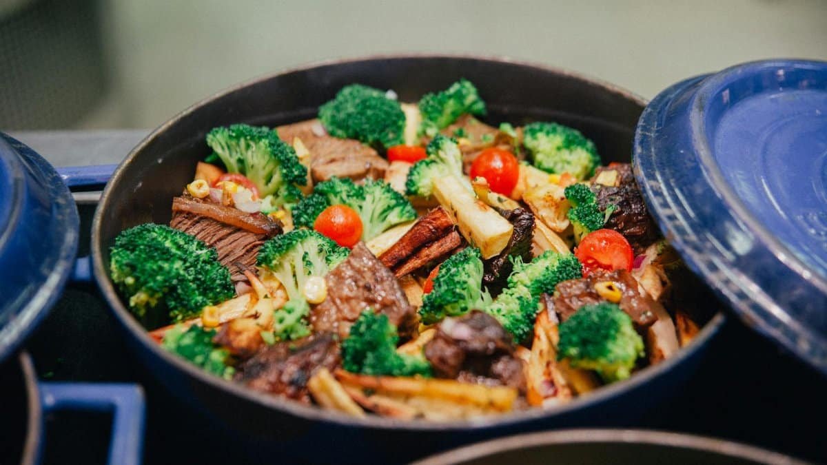 Vibrant dish of broccoli, beef, and veggies in a blue pan, perfect for dinner or lunch.