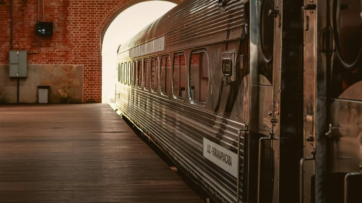 Classic train emerging from Paranapiacaba station tunnel, São Paulo, Brazil, showcasing historic charm.