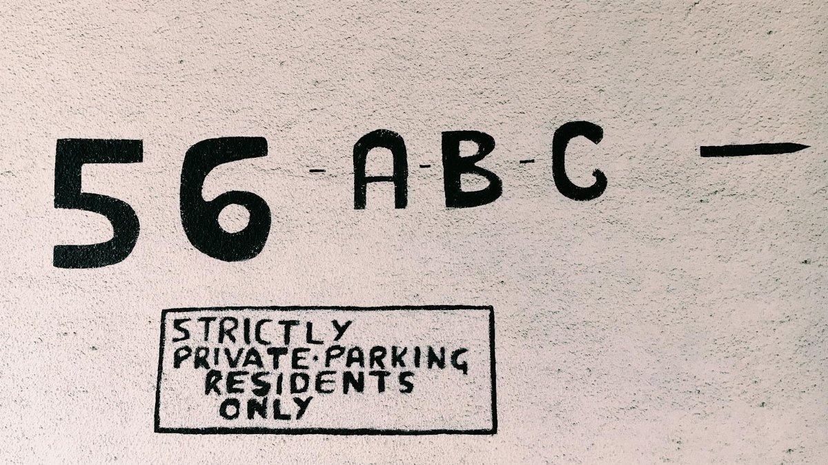 Strictly private parking sign displaying number 56, ABC, and residents only notice