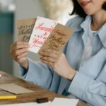 Woman holding greeting cards for holidays like Father's Day and New Year's.