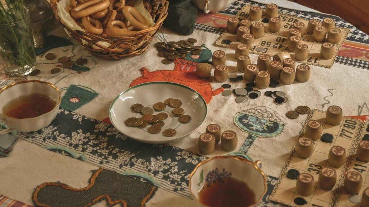 A cozy setting with bingo game elements, snacks, and tea on a table.