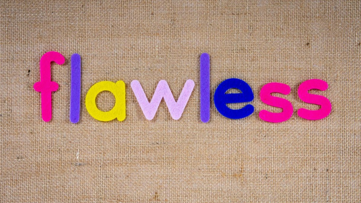 Brightly colored letters spelling 'flawless' on burlap texture.