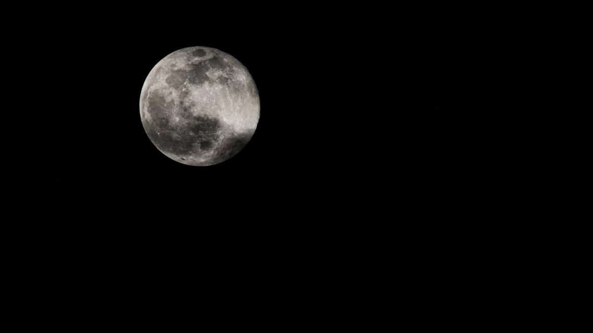 A captivating image of the full moon set against a clear, dark night sky.