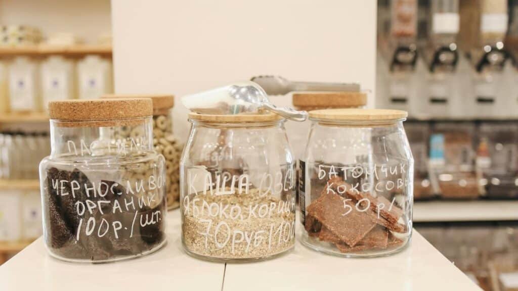 Glass jars with organic snacks on a counter in an eco-friendly zero waste store.
