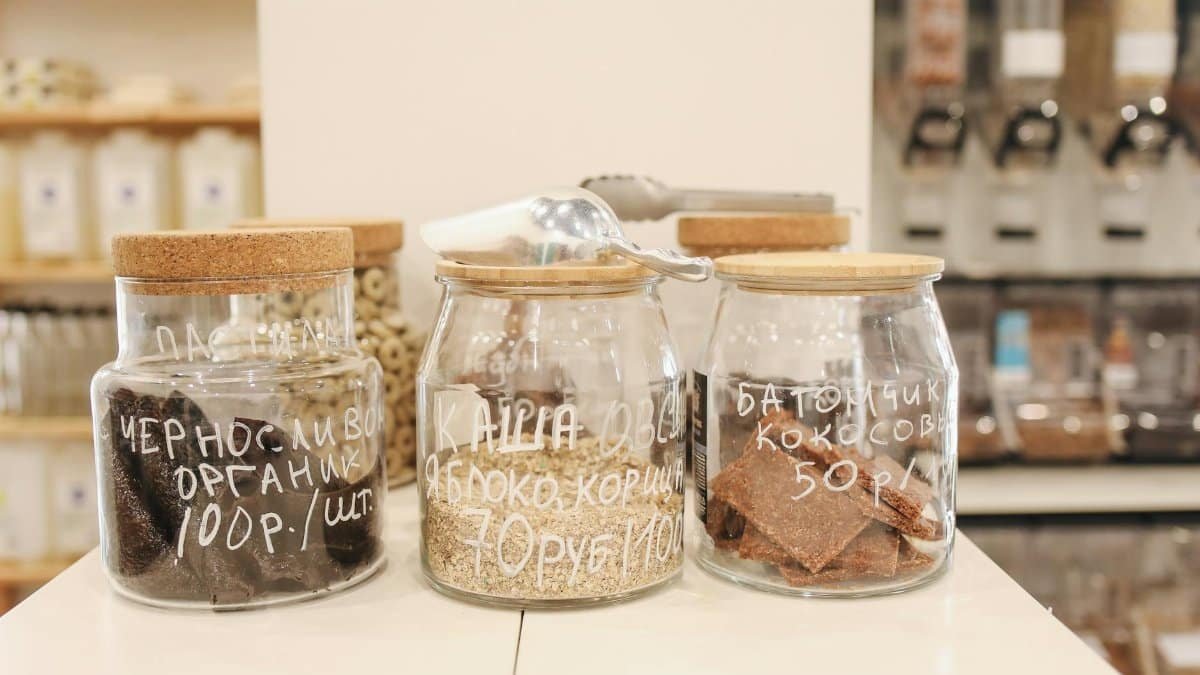 Glass jars with organic snacks on a counter in an eco-friendly zero waste store.