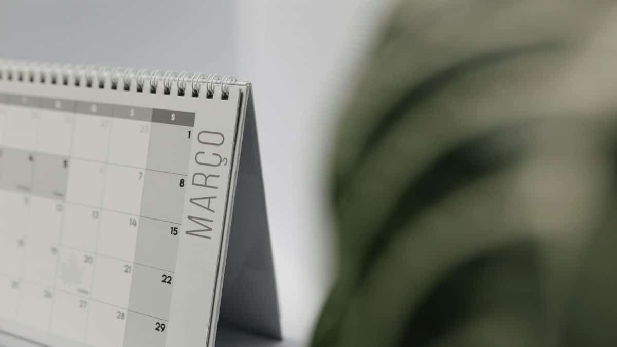 A close-up shot of a desk calendar open on March, with a soft, minimalistic background.