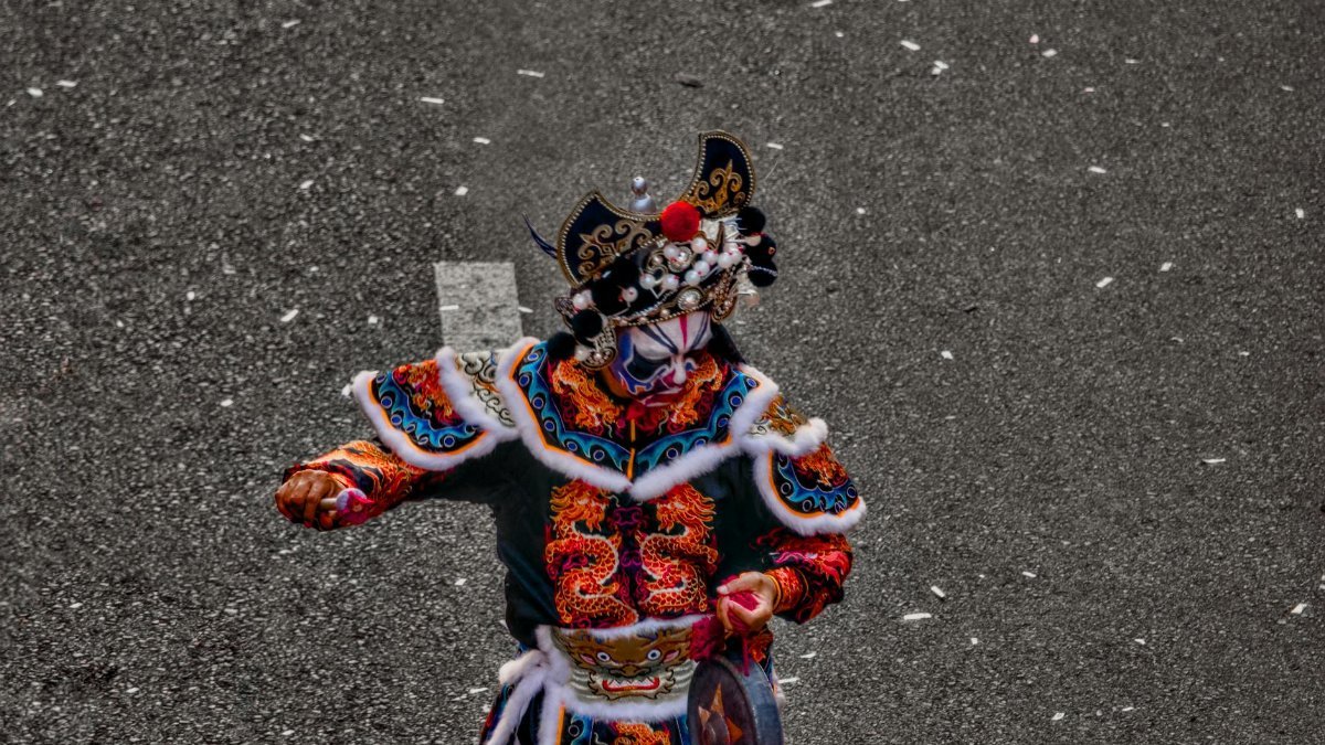 A vibrantly dressed performer in traditional costume, showcasing cultural heritage and artistic design.