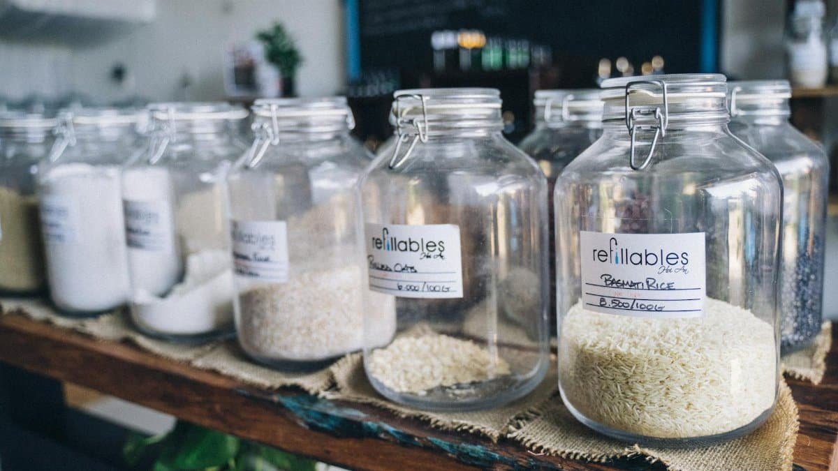 Glass jars in an eco-friendly refill shop filled with organic grains and items on display.