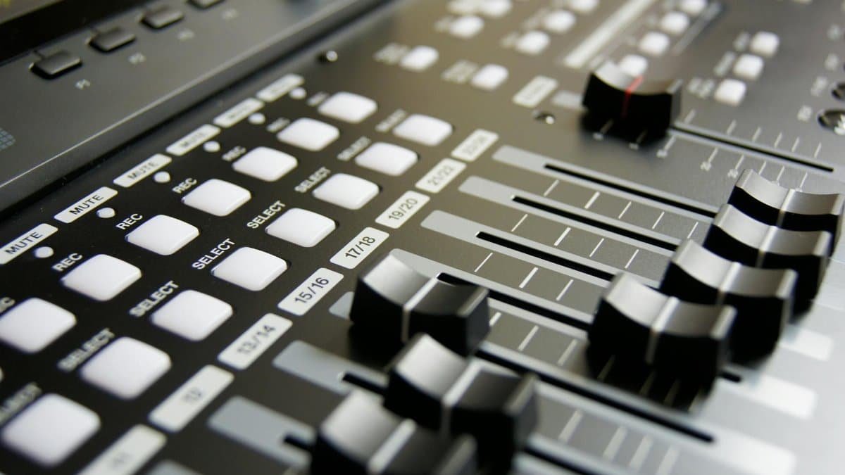Detailed view of audio mixer sliders and buttons for sound engineering and music production.