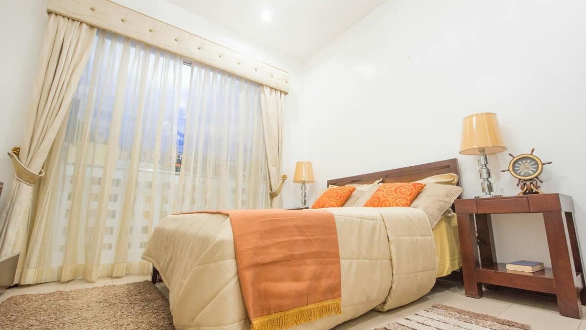 Warm and inviting bedroom featuring chic interior design and modern furnishings.
