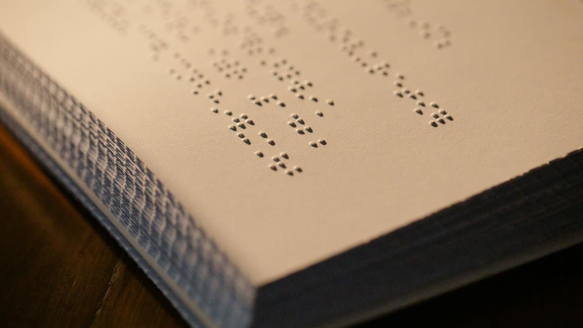Detailed close-up of embossed Braille text on paper with a shallow depth of field.