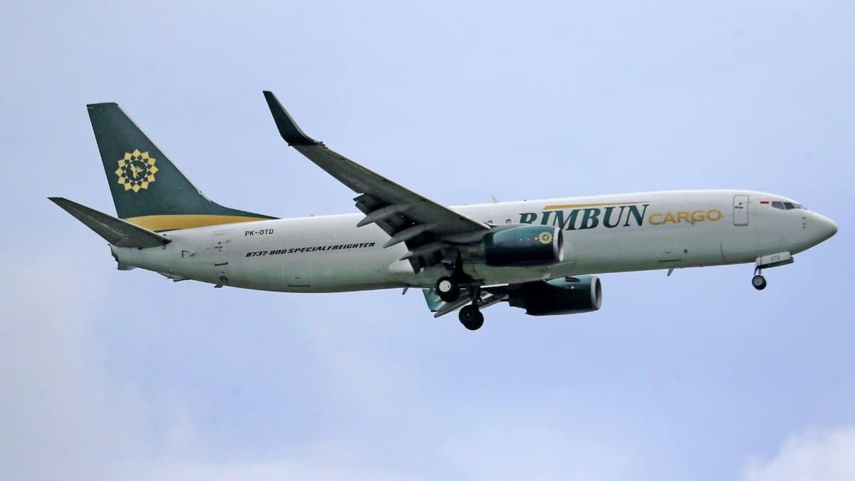 A Rimbun Cargo Boeing plane soaring through the sky, depicting freight transportation.