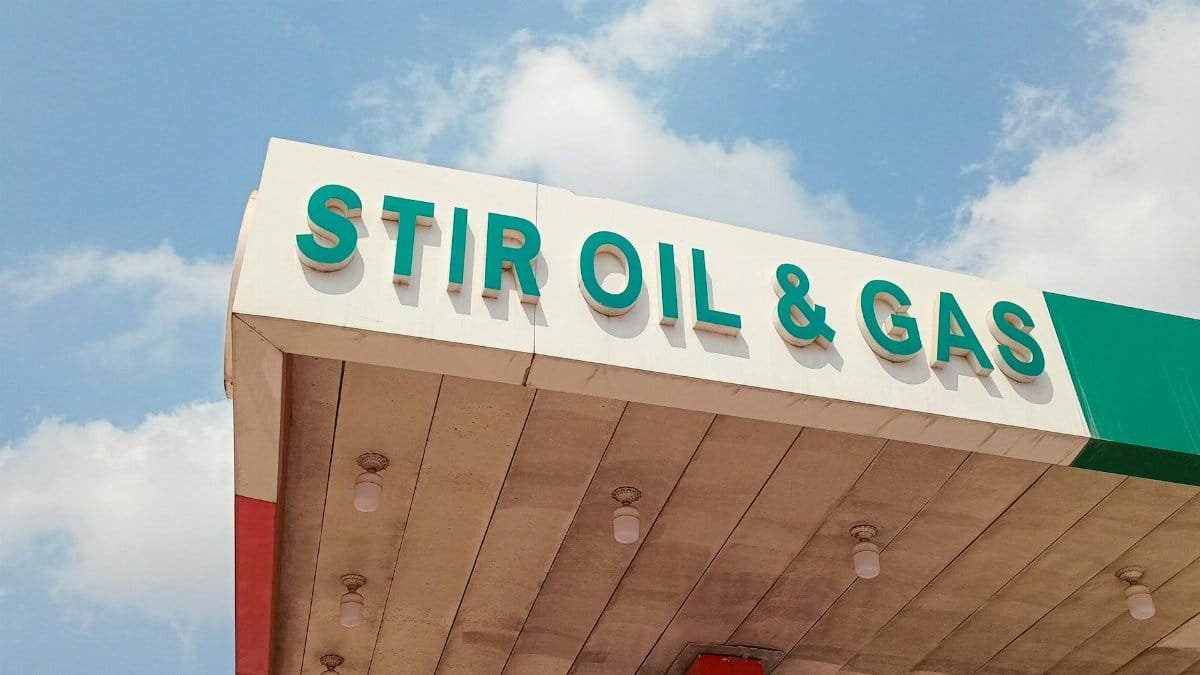 Close-up of Stir Oil & Gas sign at a filling station in Ikorodu, Nigeria under bright sky.