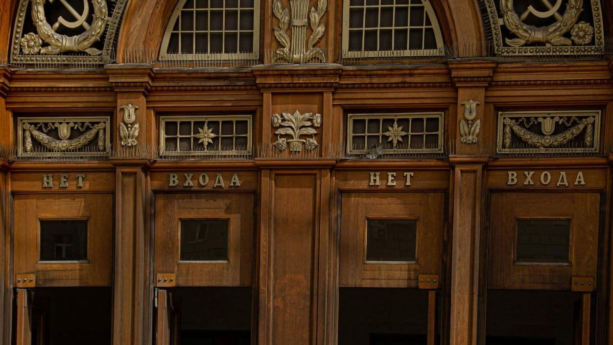 Intricate wooden entrance of a Moscow metro station displaying Soviet symbolism.