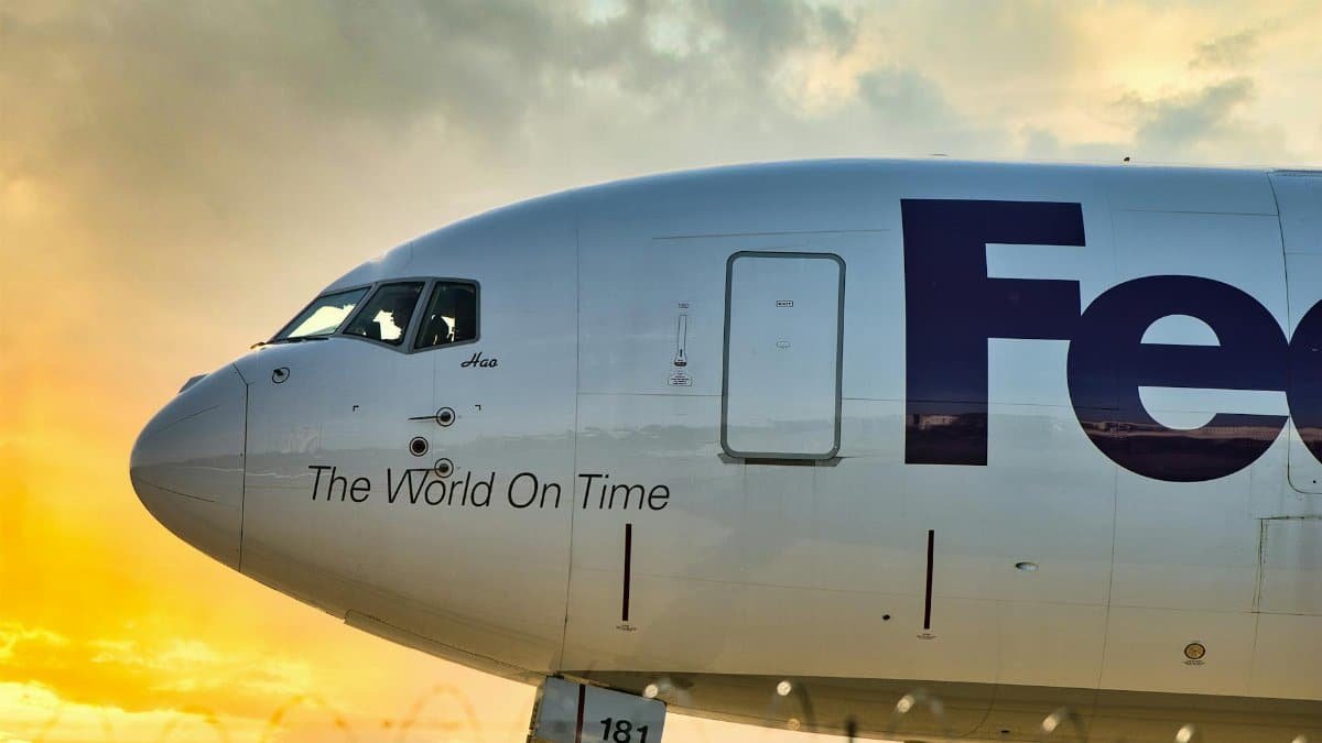FedEx cargo airplane depicted with vibrant sunset sky at Memphis Airport, showcasing logistics theme.