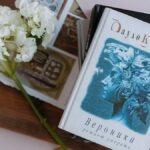 Flat lay of books with white hydrangea blooms, creating a serene and artistic composition.