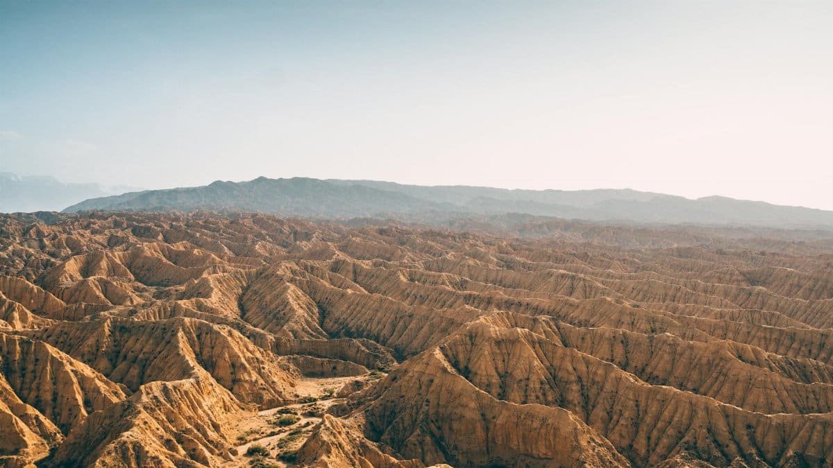Stunning aerial view of Anza-Borrego desert's rugged terrain under clear blue skies.