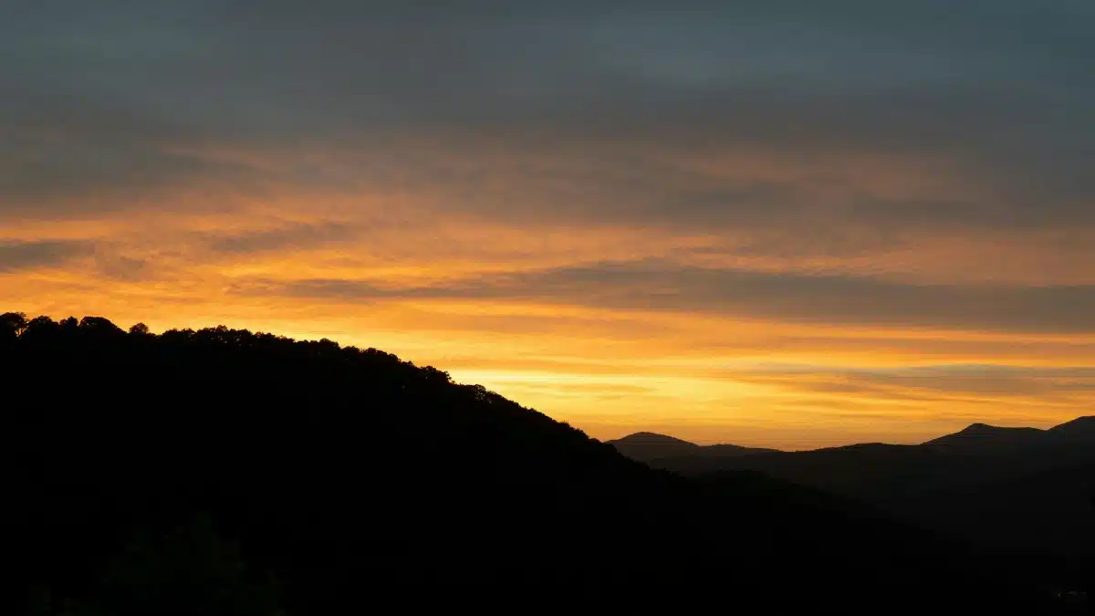 Stunning sunset with glowing skies over the Blue Ridge Mountains, Asheville, North Carolina.