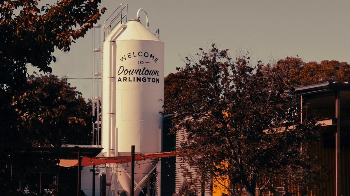 Industrial scene in Arlington, Texas featuring a prominent silo and surrounding autumn foliage.