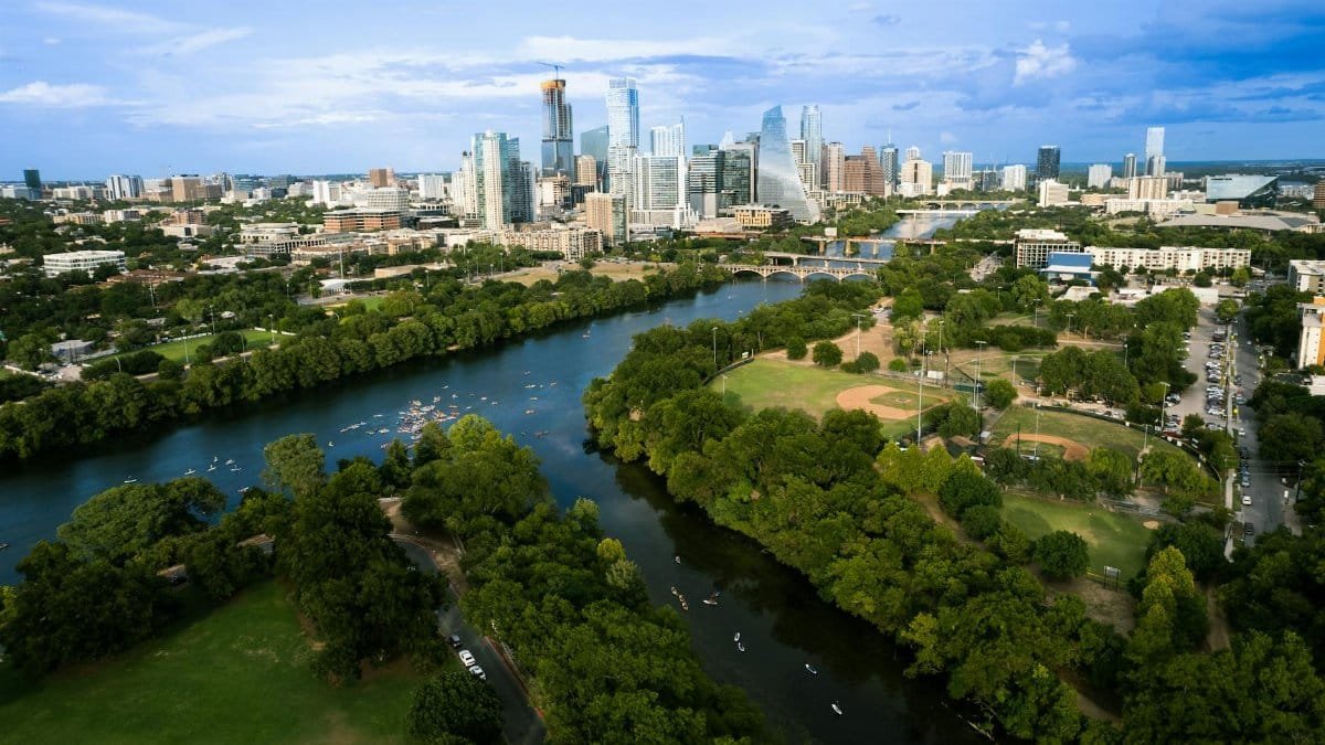 Experience Austin's vibrant skyline and scenic Colorado River from above, capturing the essence of a summer day.