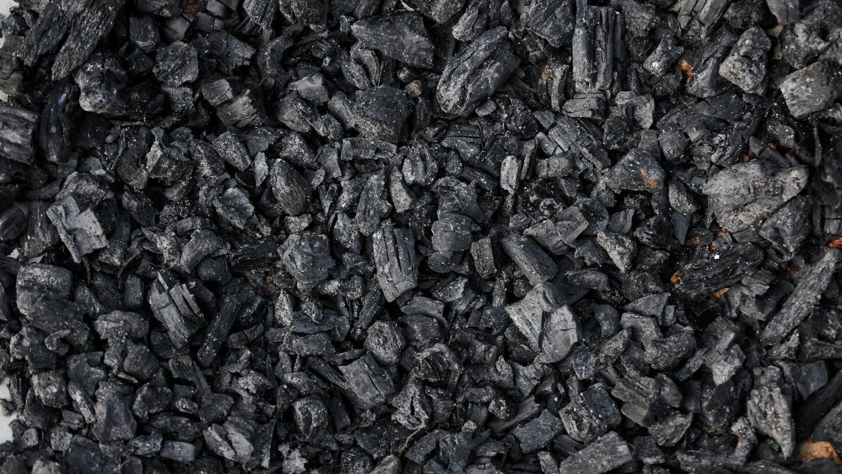 High-resolution image showing a detailed view of charcoal pieces, ideal for fuel or artistic use.